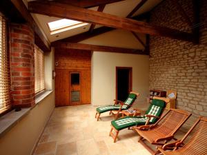 a living room with rocking chairs and a skylight at 4 Bed in Slingsby oc-g0146 in Hovingham