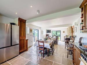 a kitchen and dining room with a table and a refrigerator at 8 Bed in Ripon oc-72263 in Grantley