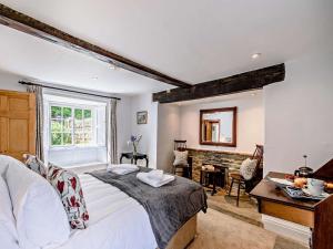a bedroom with a bed and a desk and a fireplace at 8 Bed in Ripon oc-72263 in Grantley