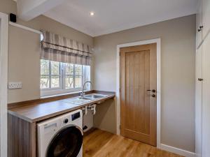 a kitchen with a washing machine and a sink at 3 Bed in Thirsk oc-91245 in Sessay +30 photos