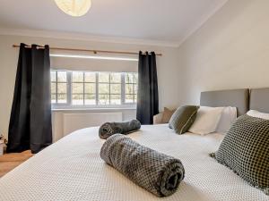 a bedroom with two beds with animal pillows on them at 3 Bed in Thirsk oc-91245 in Sessay