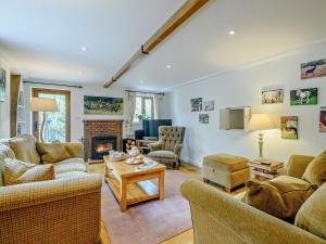 a living room with two couches and a fireplace at 4 Bed in Lymington oc-nfl94 in Sway
