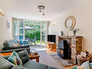 a living room with a couch and a fireplace at 3 Bed in Dorchester oc-92415 in Frome Vauchurch