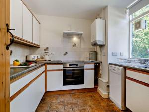 a kitchen with white cabinets and a stove top oven at 3 Bed in Dorchester oc-92415 in Frome Vauchurch +18 photos