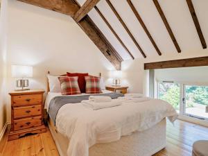 a bedroom with a large bed and a wooden floor at 3 Bed in Dorchester oc-92415 in Frome Vauchurch