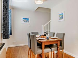 a dining room with a wooden table and chairs at 3 Bed in Dorchester oc-92414 in Frome Vauchurch +18 photos