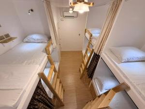 a room with four bunk beds in it at AMIGOS Hostel El Nido in El Nido