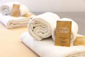 a pile of towels sitting on a pile of towels at Approdo Rooms - Eja Sardinia in Cagliari +57 photos