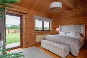 a bedroom with a bed and a large window at Penhill in Constable Burton