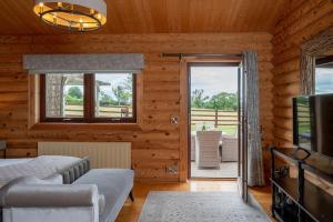 a bedroom with a bed and a tv and a window at Penhill in Constable Burton