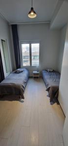 a bedroom with two beds and two windows at Apartment in seaside Helsinki 83M2 with Sauna boat to Estonia 450 m from apartment in Helsinki