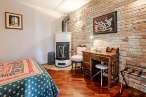 a bedroom with a brick wall with a wood stove at La tua casa meravigliosa con giardino in Fontanafredda