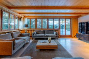 a living room with two couches and a coffee table at Chalet Eclipse, The Hidden Wonder in Hornkessel