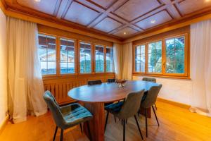 a dining room with a wooden table and chairs at Chalet Eclipse, The Hidden Wonder in Hornkessel