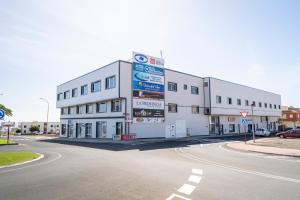 a large white building on the side of a road at Edificio Prieto VIV 8 in Puerto del Rosario +14 photos