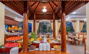 a buffet of fruits and vegetables on display in a restaurant at Hotel Somadevi Angkor Resort & Spa in Siem Reap
