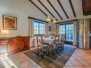 a kitchen and dining room with a table and a refrigerator at Les Cassis in Nendaz