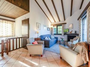 a living room with a blue couch and chairs at Les Cassis in Nendaz