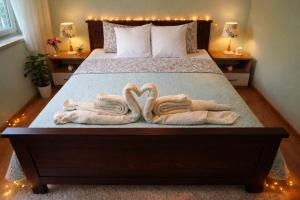 two towels in the shape of swans on a bed at President 034 in Arandelovac