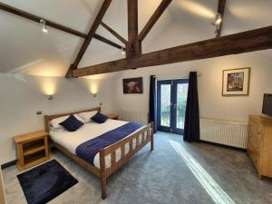 a bedroom with a bed and a tv in it at The Old Mill - Ripon Centre in Ripon