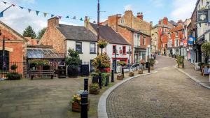 a cobblestone street in a town with buildings at The Old Mill - Ripon Centre in Ripon