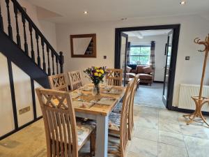 a dining room with a wooden table and chairs at The Old Mill - Ripon Centre in Ripon