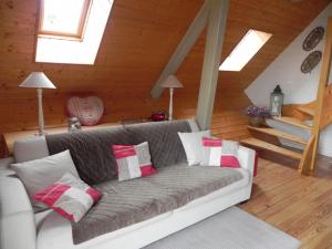 a living room with a couch with pillows at chalet besse en chandese in Besse-et-Saint-Anastaise