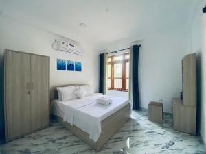 a white bedroom with a bed and a window at Anchorage Apartment in Kurunegala +64 photos