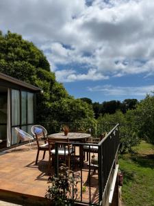 a patio with a table and chairs on a deck at Can Catrol in Santa Cristina d'Aro