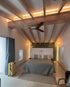 a bedroom with a bed and a ceiling at HOTEL CA'N UETAM in Valldemossa