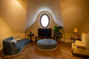 a living room with a round ottoman and a window at Winery La Gora in Irig