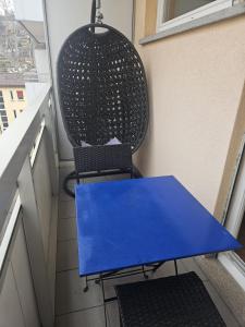 a blue table and a chair on a balcony at Tropical Lugano in Lugano