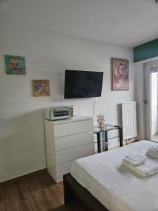 a bedroom with a bed and a flat screen tv at Tropical Lugano in Lugano