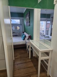 a small room with a bed and a table at Tropical Lugano in Lugano