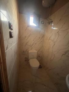 a small bathroom with a toilet and a light at Azru hotel siwa in Siwa