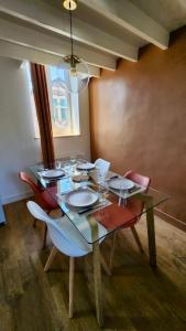 a dining room with a glass table and chairs at L'estacade in Veules-les-Roses