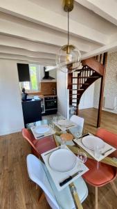 a dining room with a table with wine glasses on it at L'estacade in Veules-les-Roses