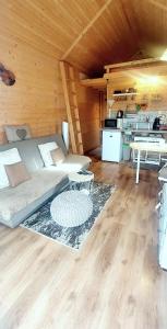 a living room with a couch and a table at Tiny House Olivia in Liptovský Hrádok