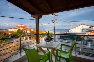 a table and chairs on a balcony with a view at Αmalia Lux Villas in Nea Vrasna