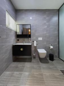 a bathroom with a sink and a tub and a toilet at Luxury Double Bed Suite at THE HIDDEN DOMUS I Anomabo Suite in Accra +2 photos