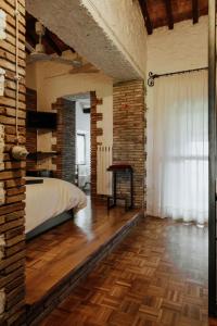 a bedroom with a bed and a brick wall at Il Paliarete in Orvieto +13 photos