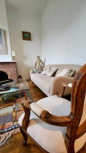 a living room with a couch and a chair at Villa Tournevent - Villa d'exception avec vue Mer - Veules-les-Roses in Veules-les-Roses