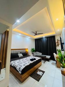 a bedroom with a bed and a living room at Moon Path Stay in Nalmatha +3 photos