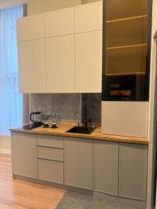 a kitchen with a sink and a counter top at LUVERDE HOTEL Sarkand in Almaty