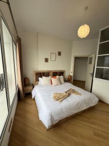 a bedroom with a large bed with a robe on it at Babrabat in Rabat