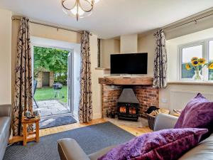 a living room with a fireplace and a tv at 2 Bed in Dorchester oc-92416 in Frome Vauchurch