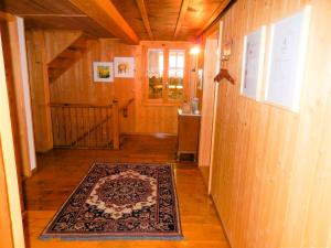a hallway of a house with a rug on the floor at BnB Haus Itten in Hondrich