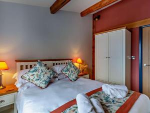 a bedroom with a white bed with two pillows at 2 Bed in Ripon oc-94559 in Masham
