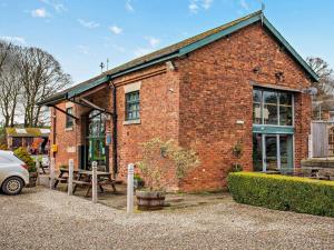 a brick building with a picnic table in front of it at 2 Bed in Ripon oc-94559 in Masham