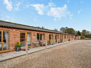 a brick building with a row of windows and chairs at 2 Bed in Ripon oc-94559 in Masham